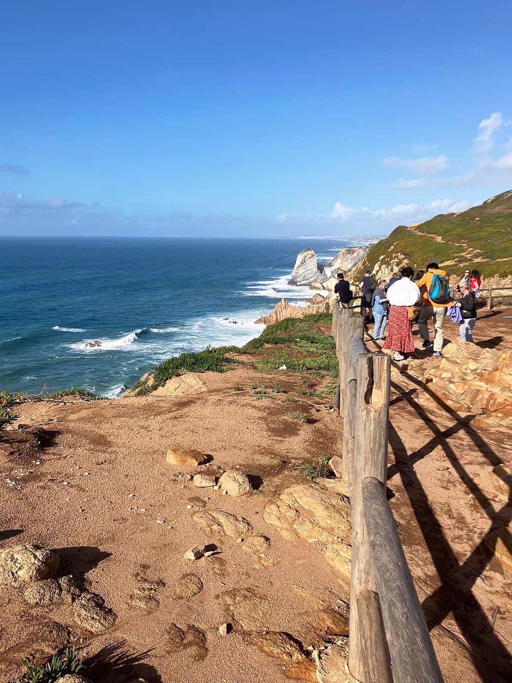 Breathtaking coastal view along the cliffs with tourists enjoying the scenic nature.