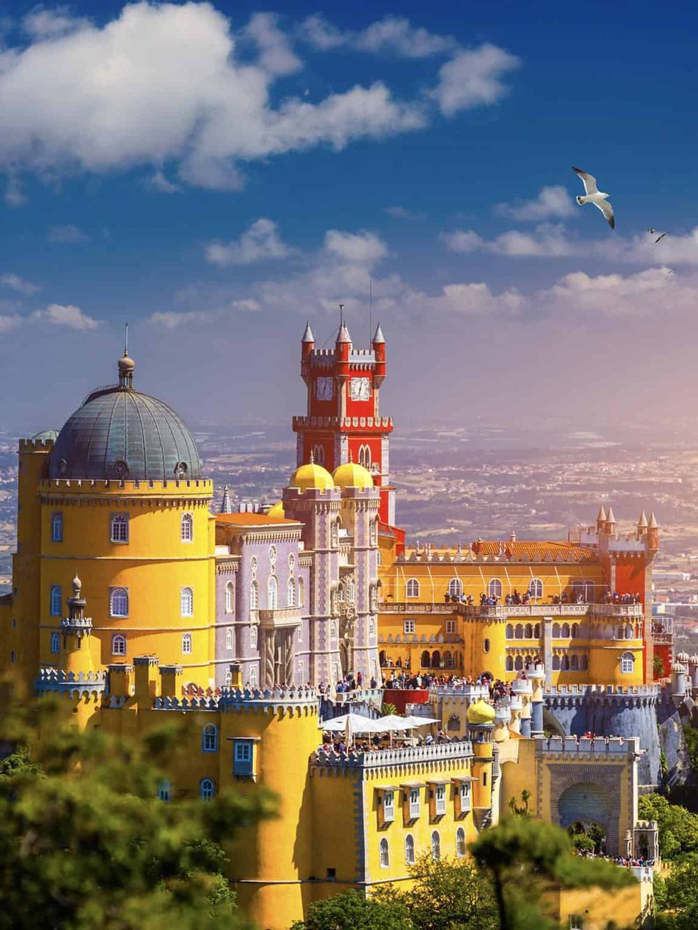 Colorful and historic Pena Palace, a 19th-century Romanticist castle in Sintra, Portugal, with vibrant architecture and stunning views.