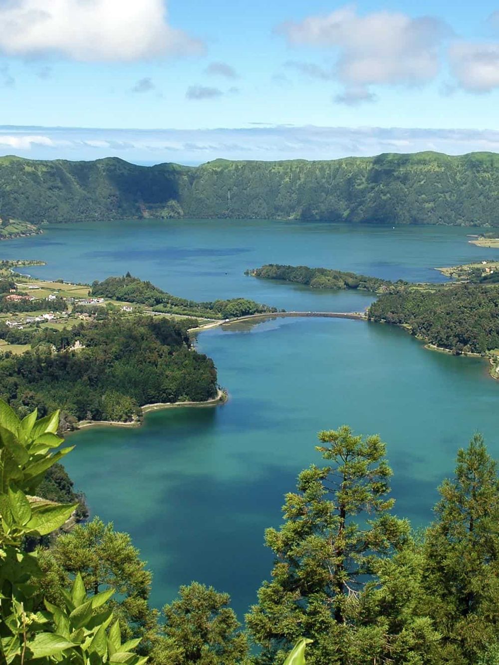 Vivid aerial view of Quest For Directions lakes surrounded by lush green forests and scenic mountains.