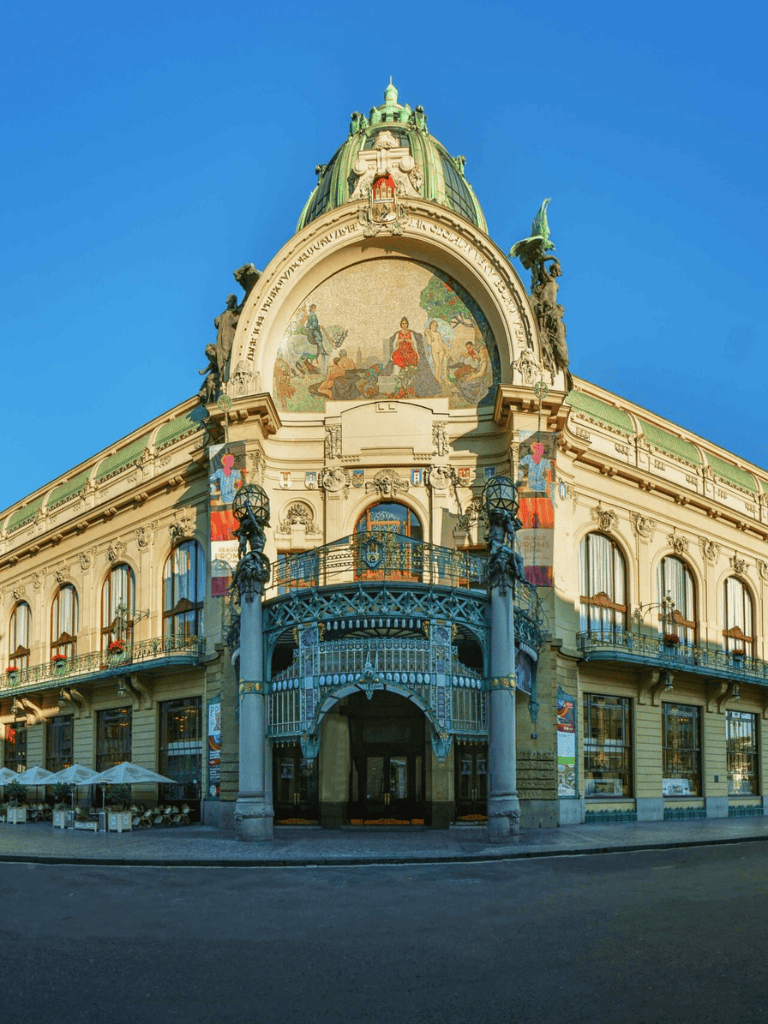 Ornate historic building with detailed architecture and colorful murals under clear blue sky.