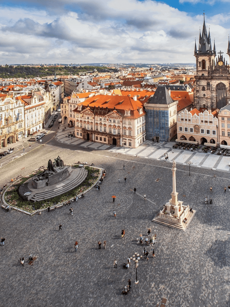 Historic square in Prague with iconic landmarks and cobblestone streets.