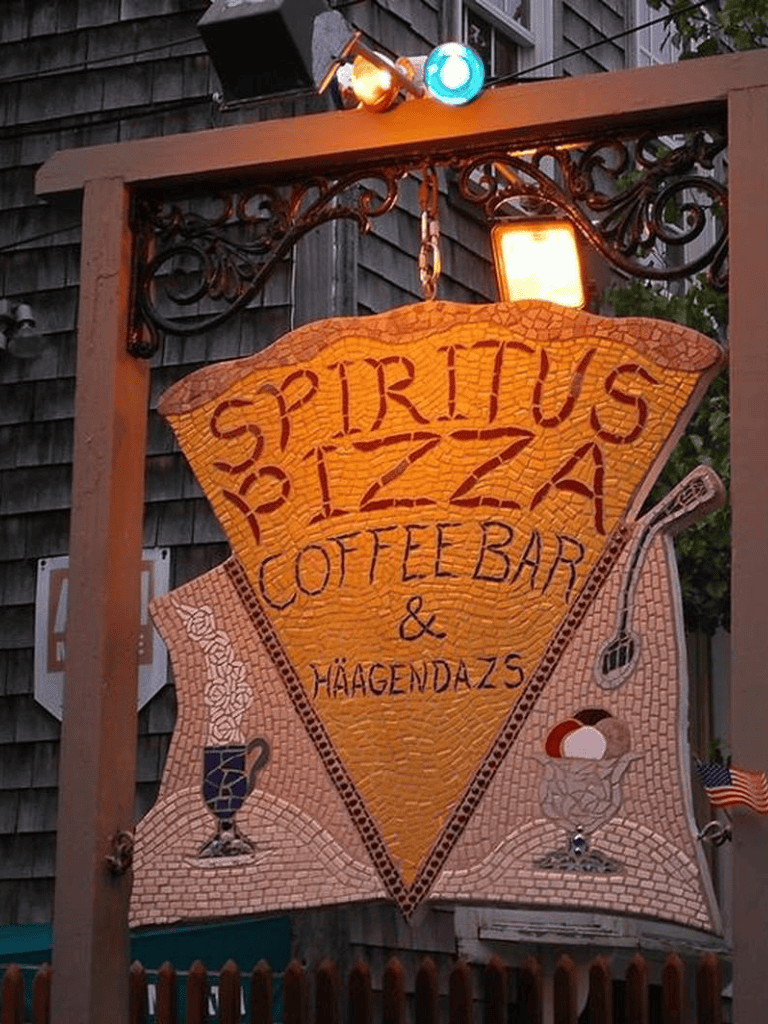 Vintage mosaic sign for Spiritius Pizza offering coffee bar and snacks, hanging outside a rustic restaurant.
