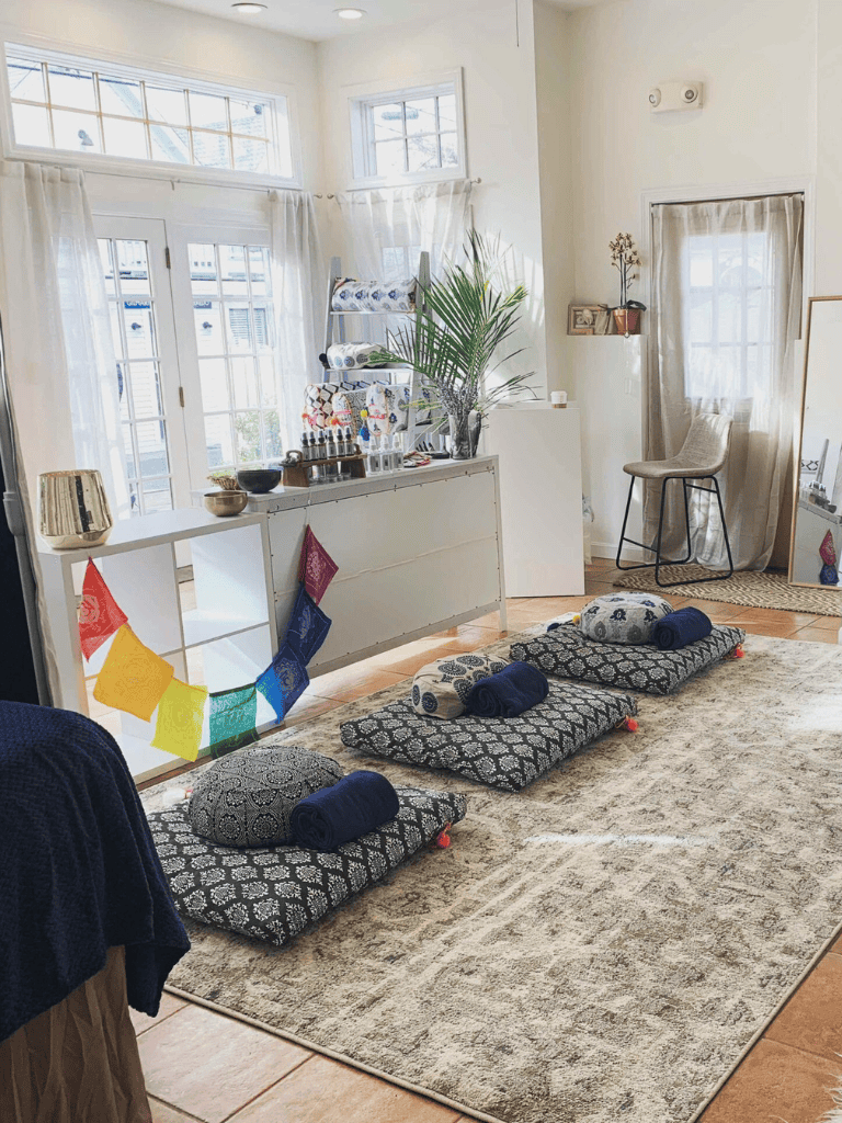 Meditation space with floor cushions and natural light.