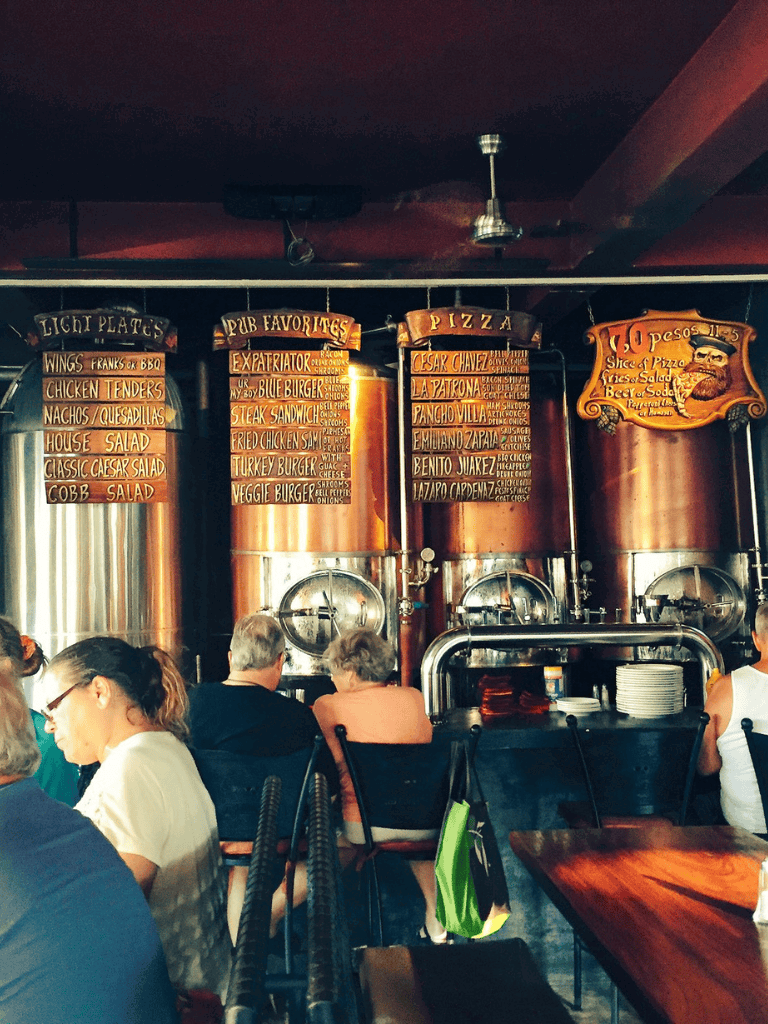 Colorful restaurant menu boards displaying pizza, pub favorites, and light plates at QuestForDirections.