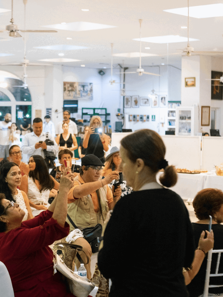 Shooting event at QuestForDirections, lively indoor gathering, diverse crowd, capturing moments, engaging audience, photography, community event.