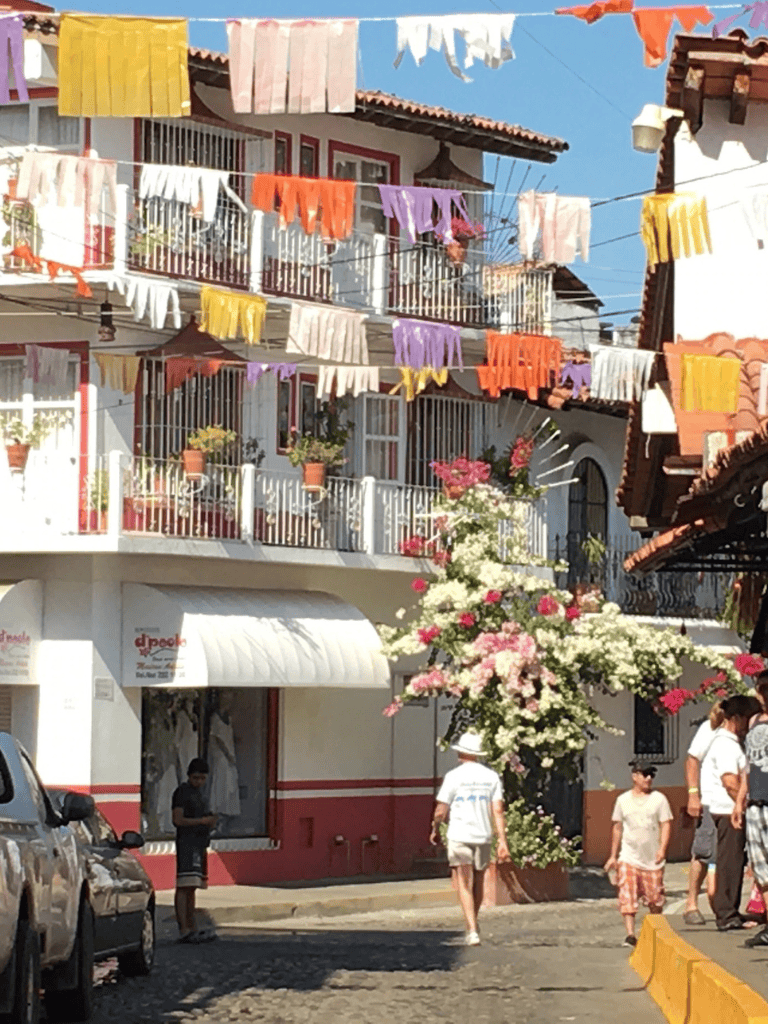 Colorful laundry hanging over a charming street in a lively neighborhood, perfect for exploring local culture.