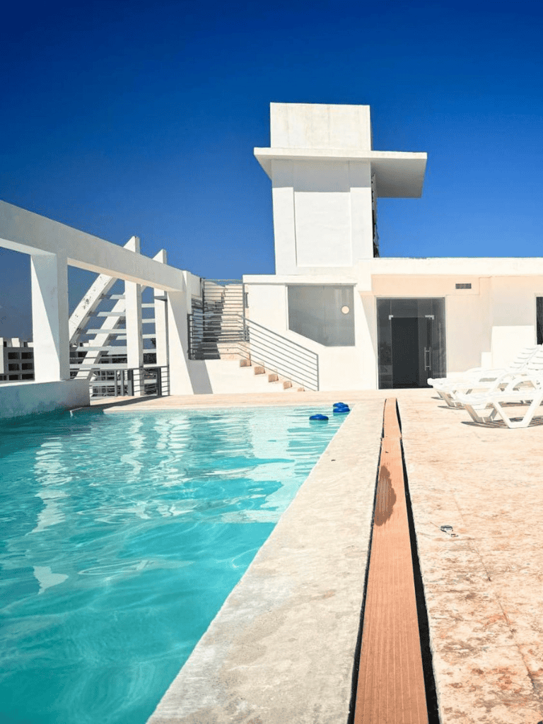 Relaxing rooftop pool with city views and modern architecture.