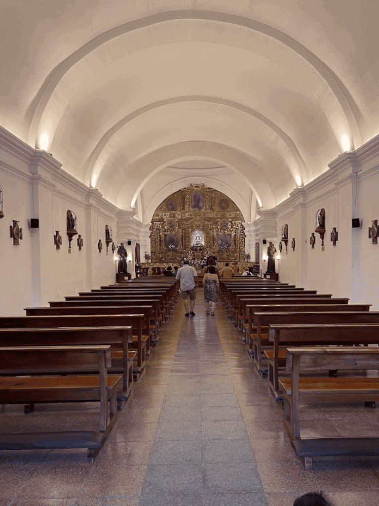 Ancient church interior with wooden pews and ornate altar, historical religious site for spiritual travel.