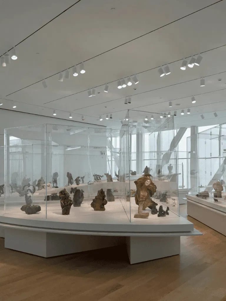 Intricate sculptures displayed in a modern museum gallery showcasing ancient artifact replicas.