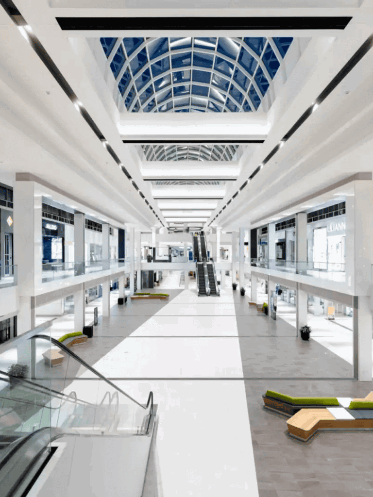 Bright, modern shopping mall with sleek architecture and spacious walkways.
