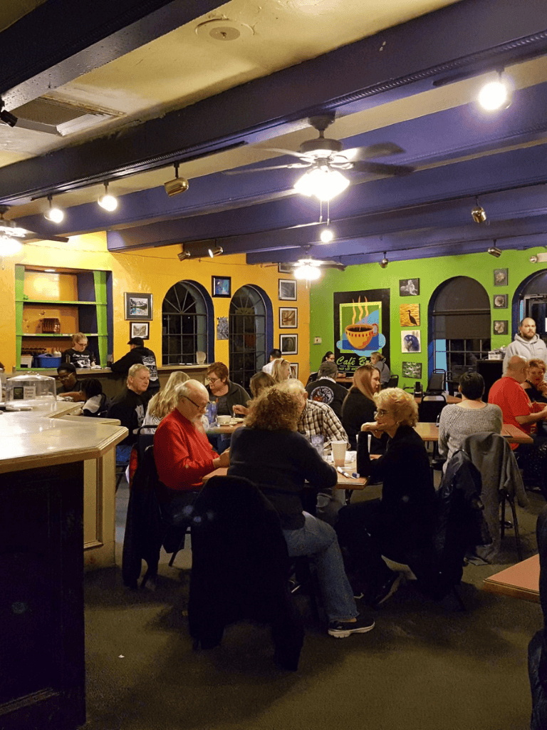 Friendly family-friendly restaurant interior with vibrant colorful walls and diverse diners enjoying their meals.
