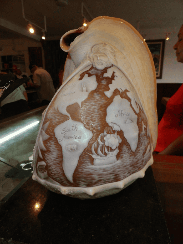 Intricately carved world map on a pumpkin, highlighting Africa, South America, and details of global geography.