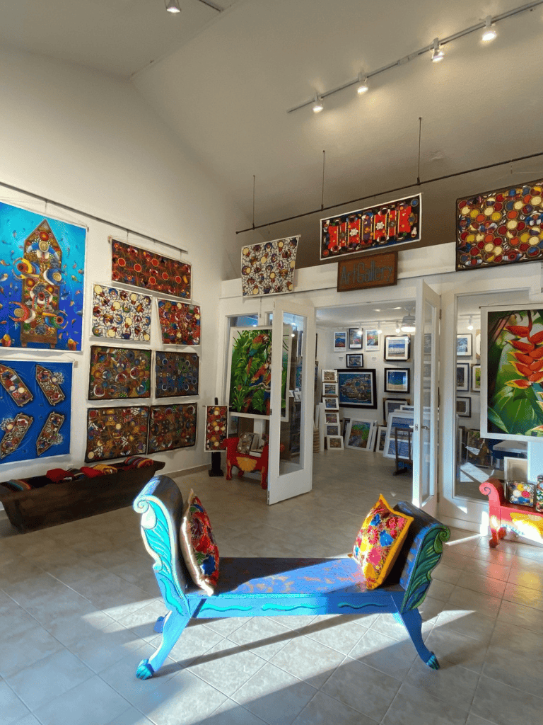 Colorful art gallery with unique painted furniture and vibrant wall art displays.