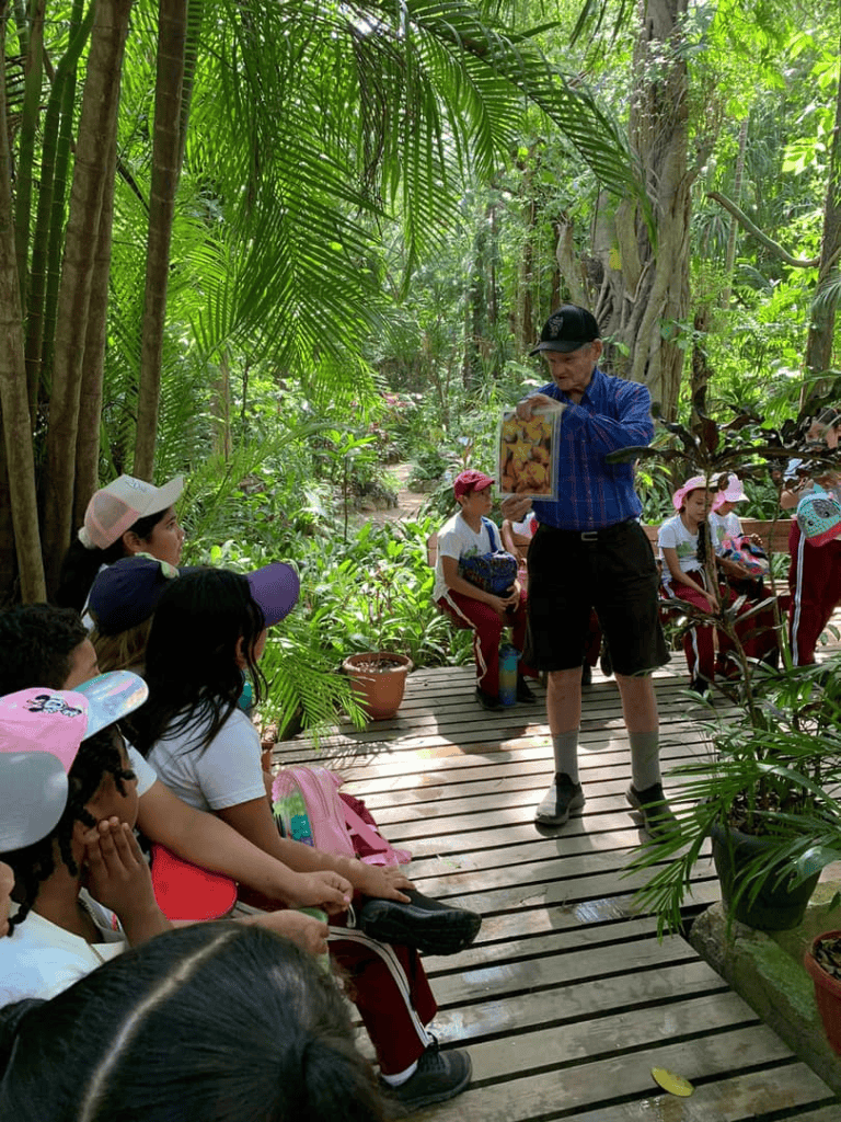 Nature educational tour with children in tropical forest setting.