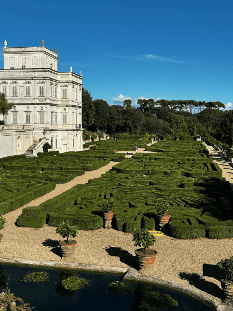 Alt text: Italian baroque architecture with formal garden and maze at Villa d'Este, Tivoli, Italy.
