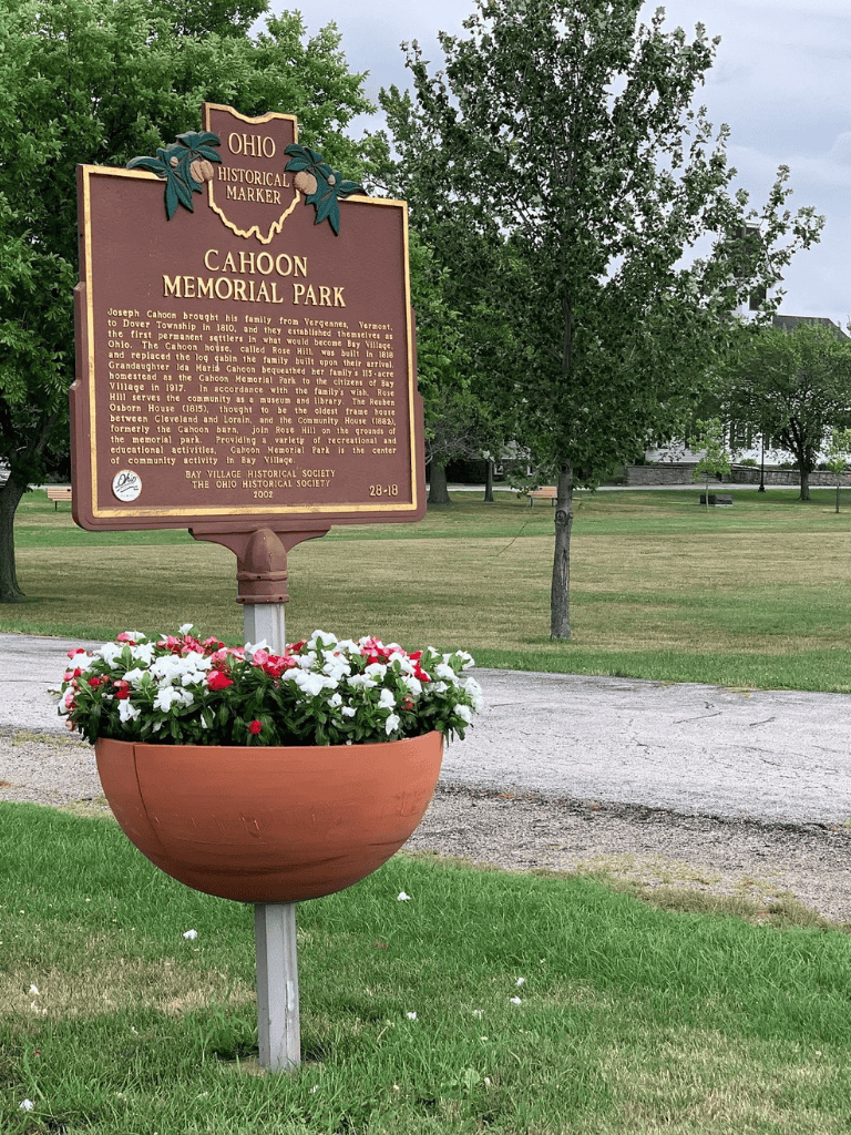 Historic Ohio historical marker at Cahoon Memorial Park, Ohio, with colorful flower planter.