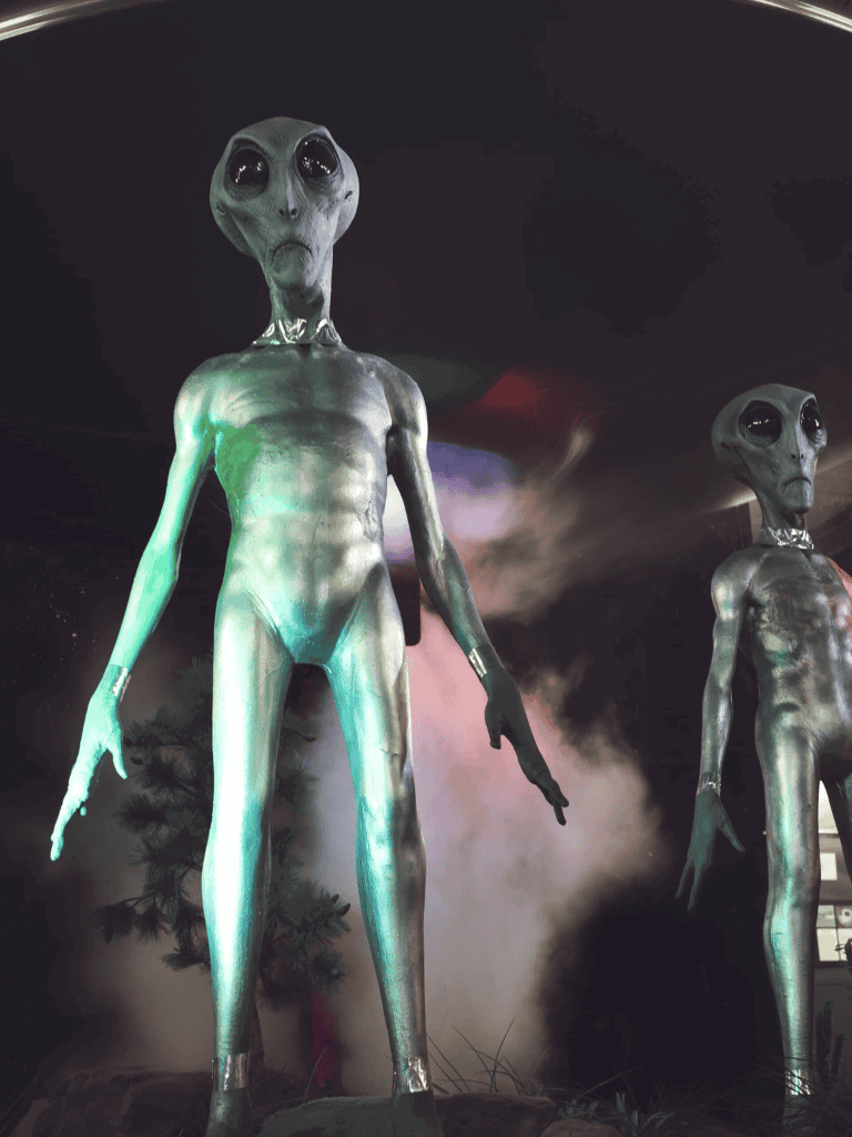 Uncanny extraterrestrial sculptures with large black eyes and slender bodies at QuestforDirections exhibit.