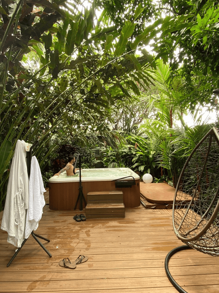 Relaxing outdoor hot tub surrounded by lush tropical greenery for ultimate relaxation.