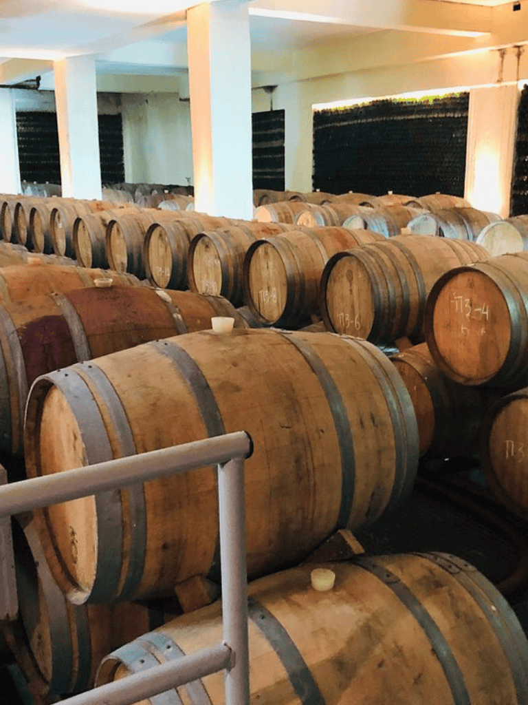 Aged wine barrels in a cellar at QuestForDirections winery.