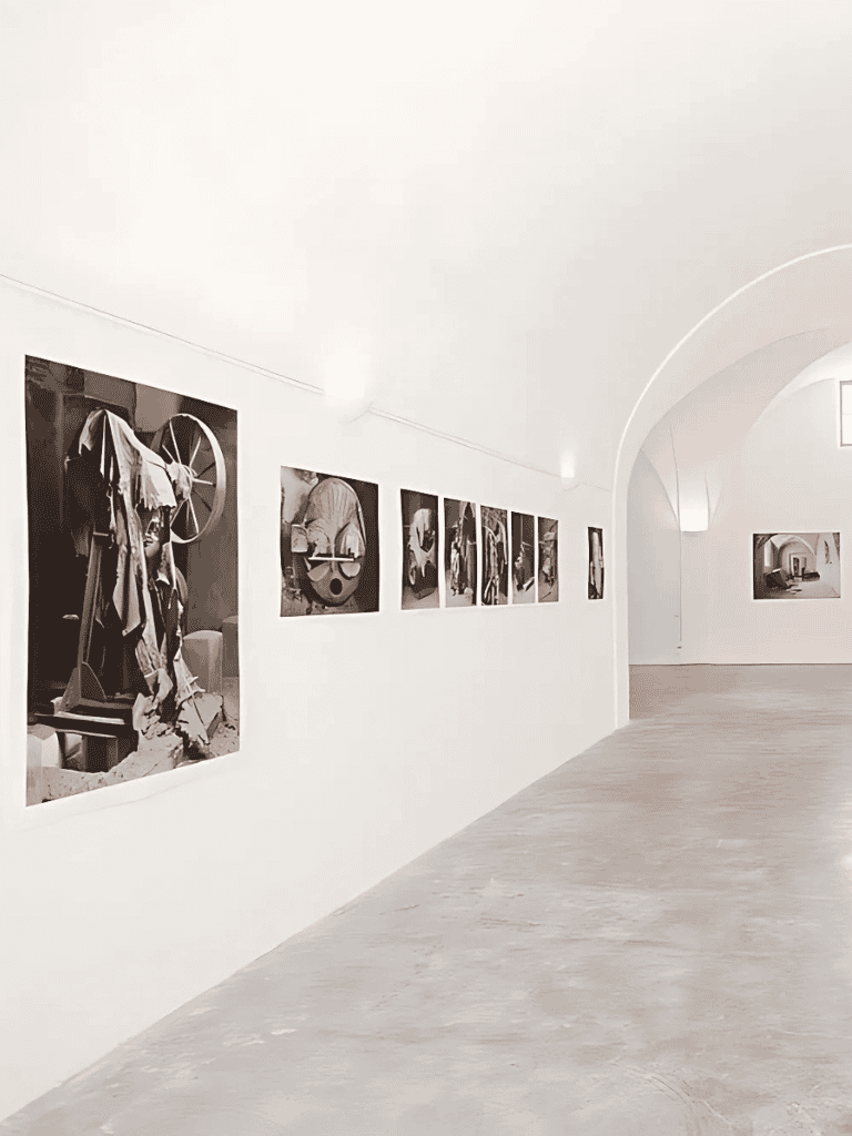 Worn-out mechanical objects displayed in art gallery, black and white photographs, QuestForDirections exhibit.