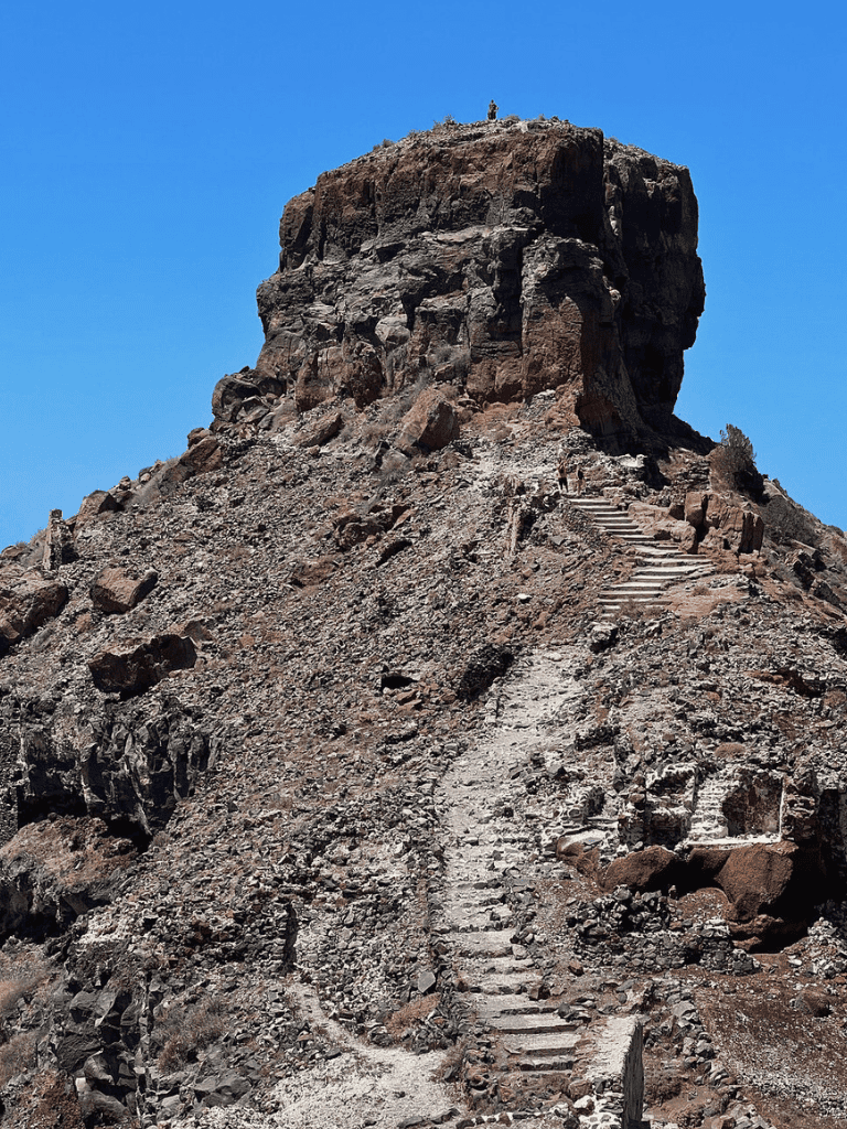 Steep mountain trail with stone steps leading to the top - adventurous hiking route.