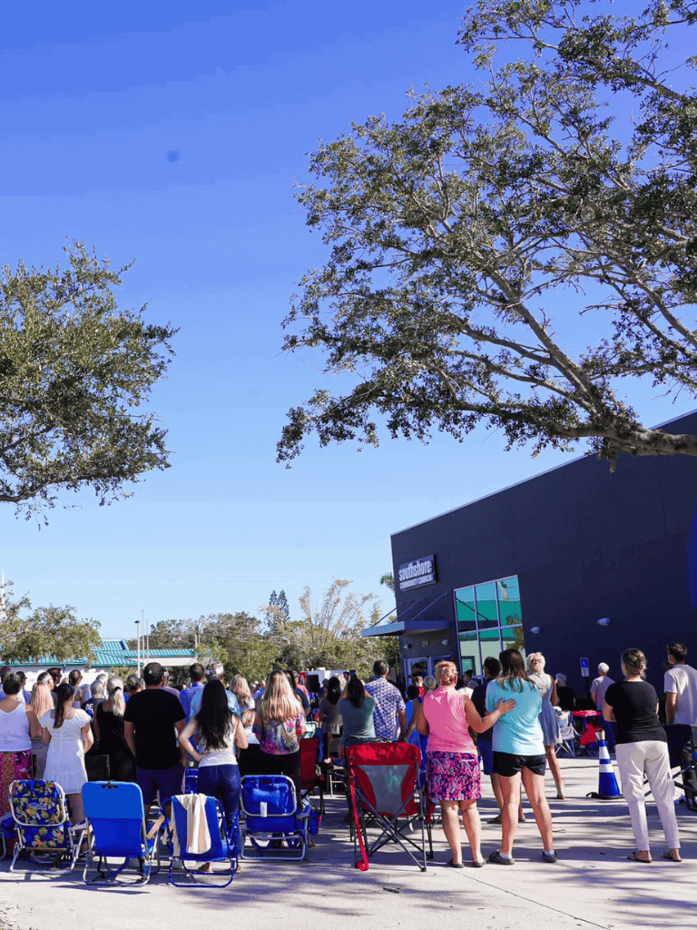 People gathering outside Southshore Community Center for community event or concert.