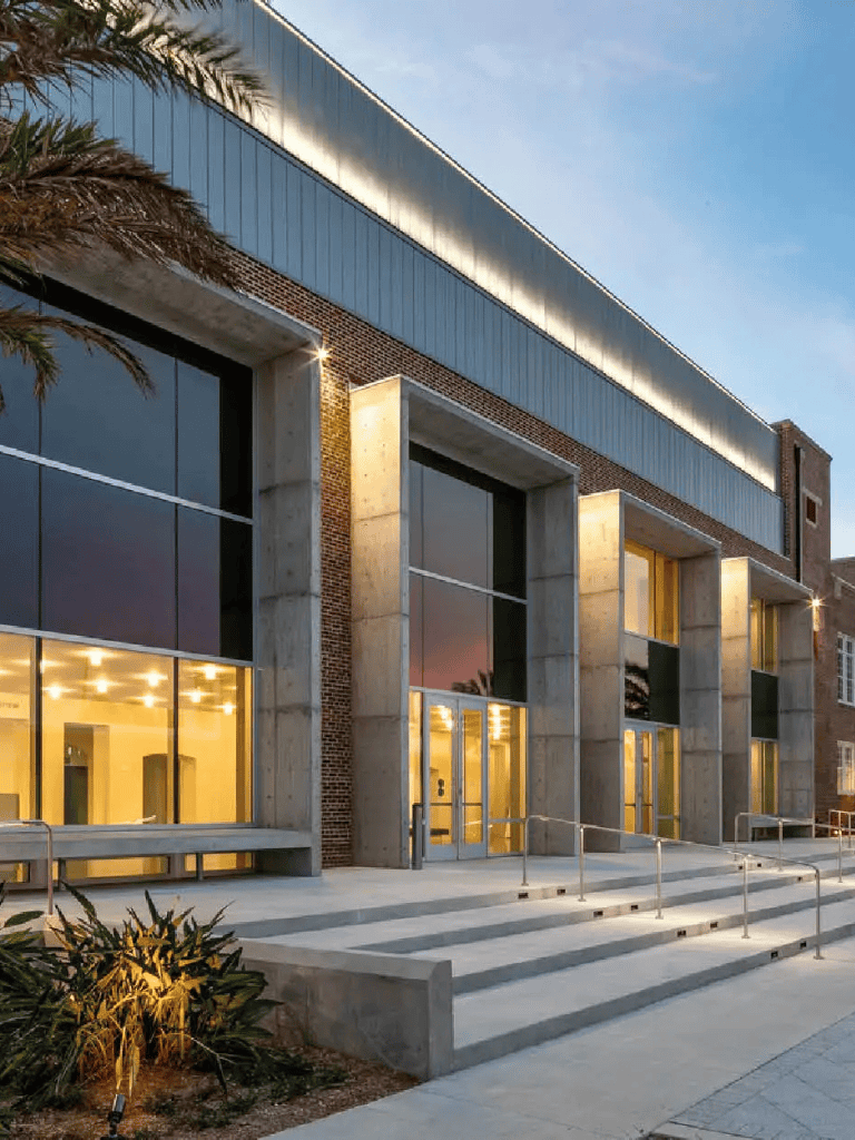 Modern institutional building with large glass windows and concrete accents.