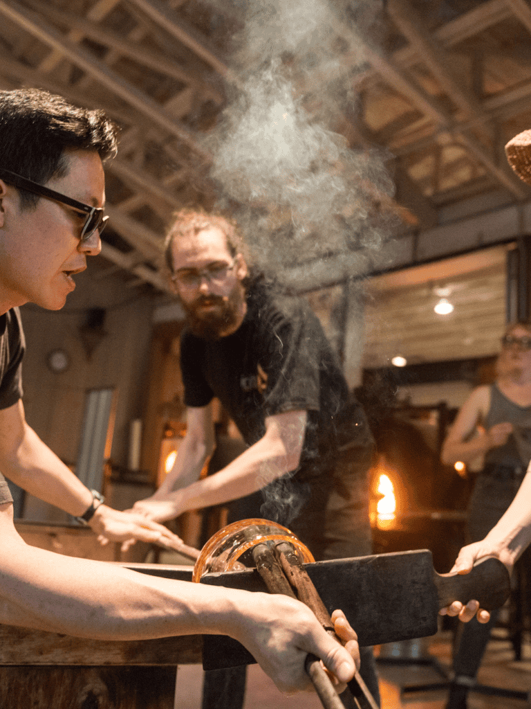 Iron forging workshop with artisans, traditional blacksmithing process, QUEST FOR DIRECTIONS, hands-on experience, making metal tools, authentic craft.