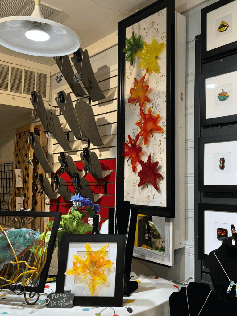 Yellow, red, and orange maple leaf artwork displayed at QuestForDirections retail store, perfect for fall home decor.