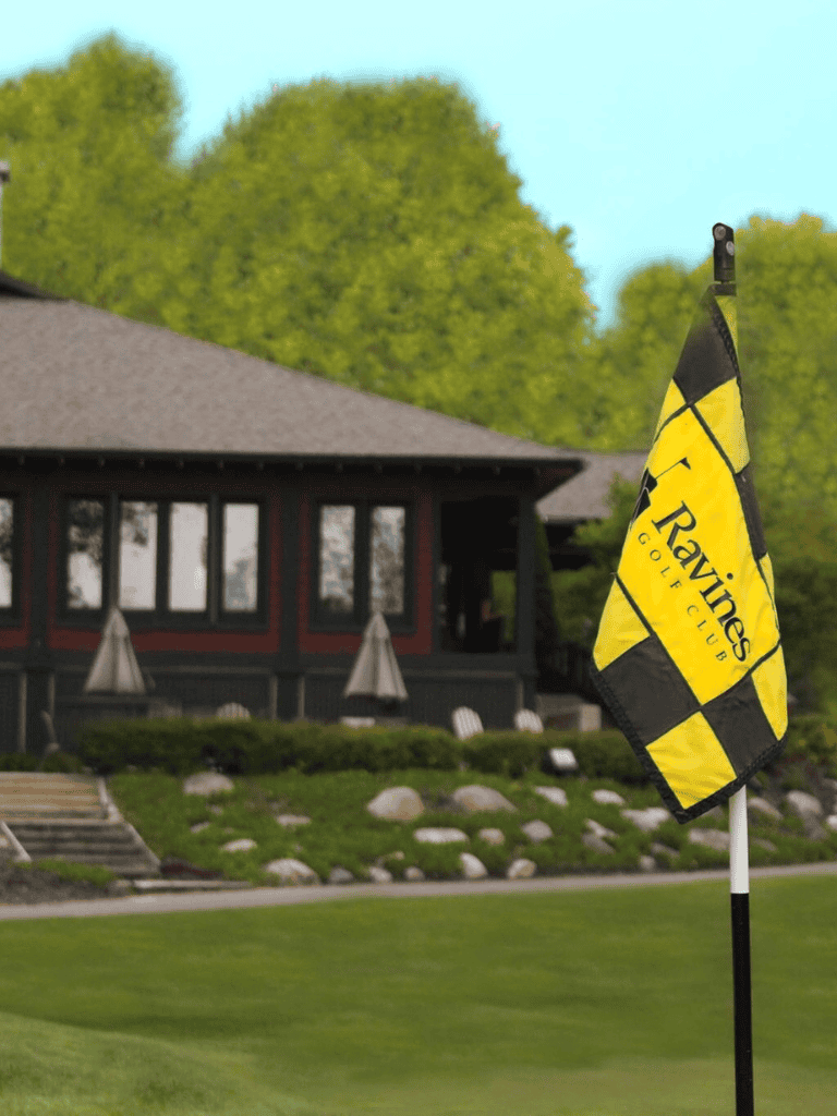 Flag at Ravines Golf Club, lush green fairway, scenic golf course setting, perfect for golf enthusiasts.