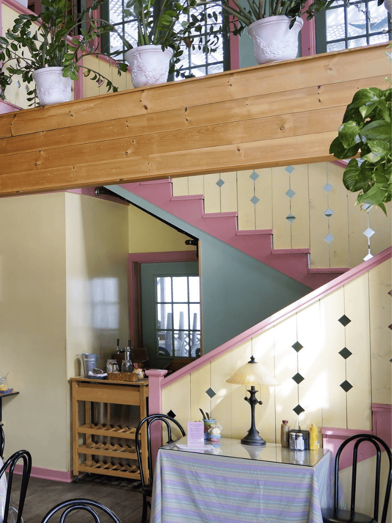 Bright cozy restaurant interior with colorful walls and potted plants, ideal for dining and casual meetings.