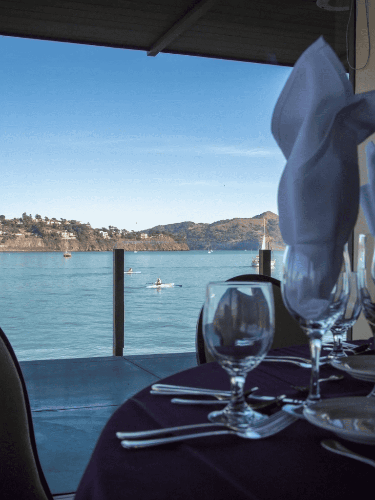 Serene waterfront dining with ocean view and elegant table setting at QuestForDirections.