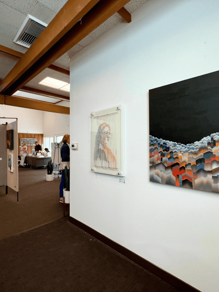 Colorful abstract art gallery at QuestForDirections art exhibition, showcasing modern paintings.