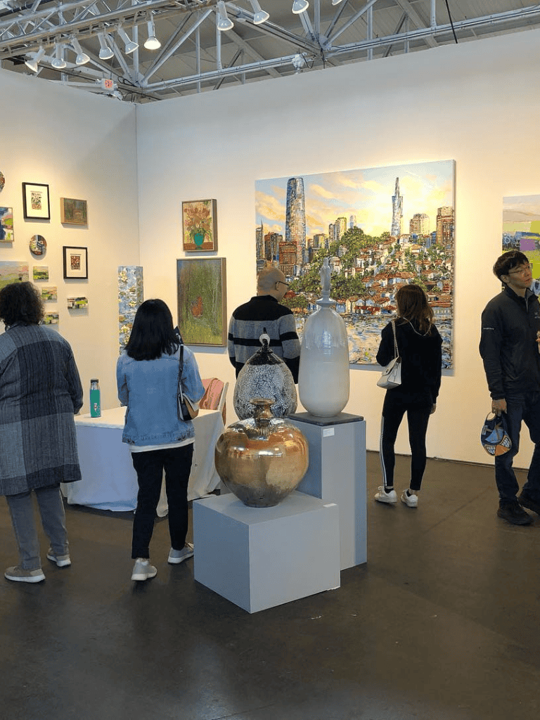 Vibrant art gallery showcasing paintings and ceramics at QuestForDirections exhibit.