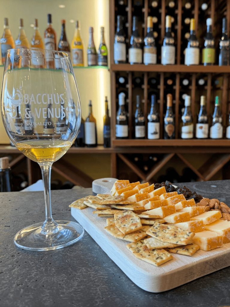 Wine and cheese tasting at a cozy winery with a selection of crackers and nuts, perfect for wine enthusiasts and food lovers.