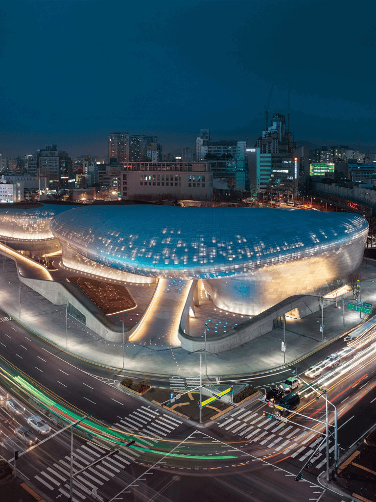 Modern cityscape with QuestForDirections logo, night view of urban skyline and futuristic architecture.