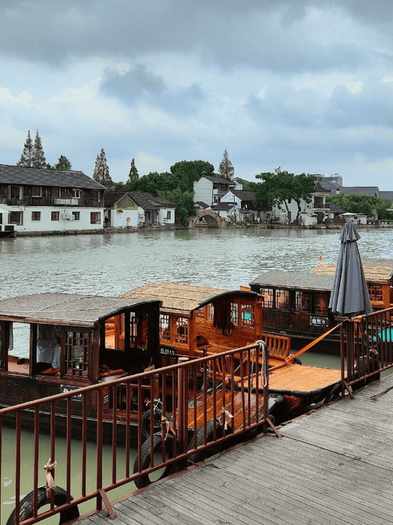 Old Chinese river houses and wooden boats on a canal in Suzhou, China.