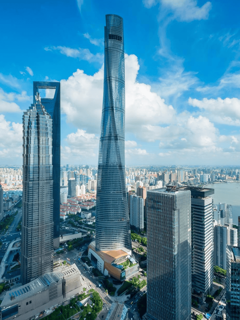Aerial view of Shanghai Tower, showcasing modern skyscrapers in a vibrant city skyline.