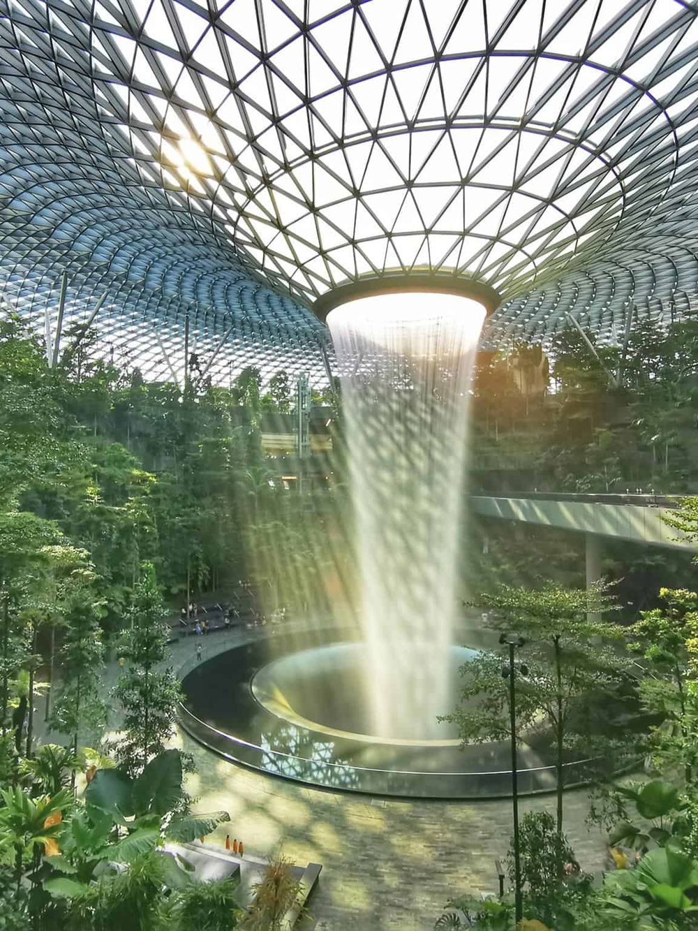Modern indoor waterfall with a glass dome ceiling at QuestForDirections.