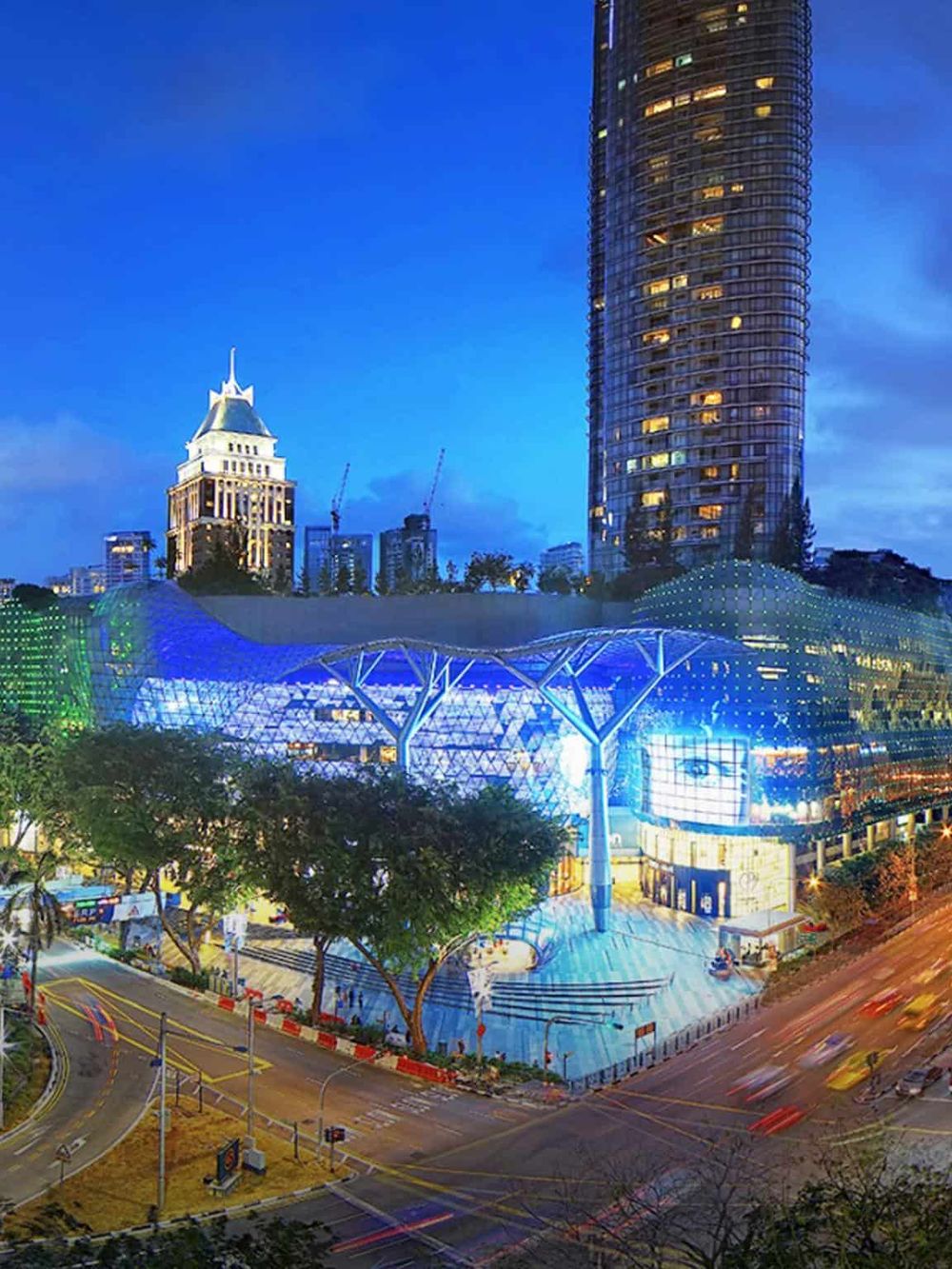 Bright cityscape of downtown with modern architecture and illuminated buildings at dusk, showcasing urban development.
