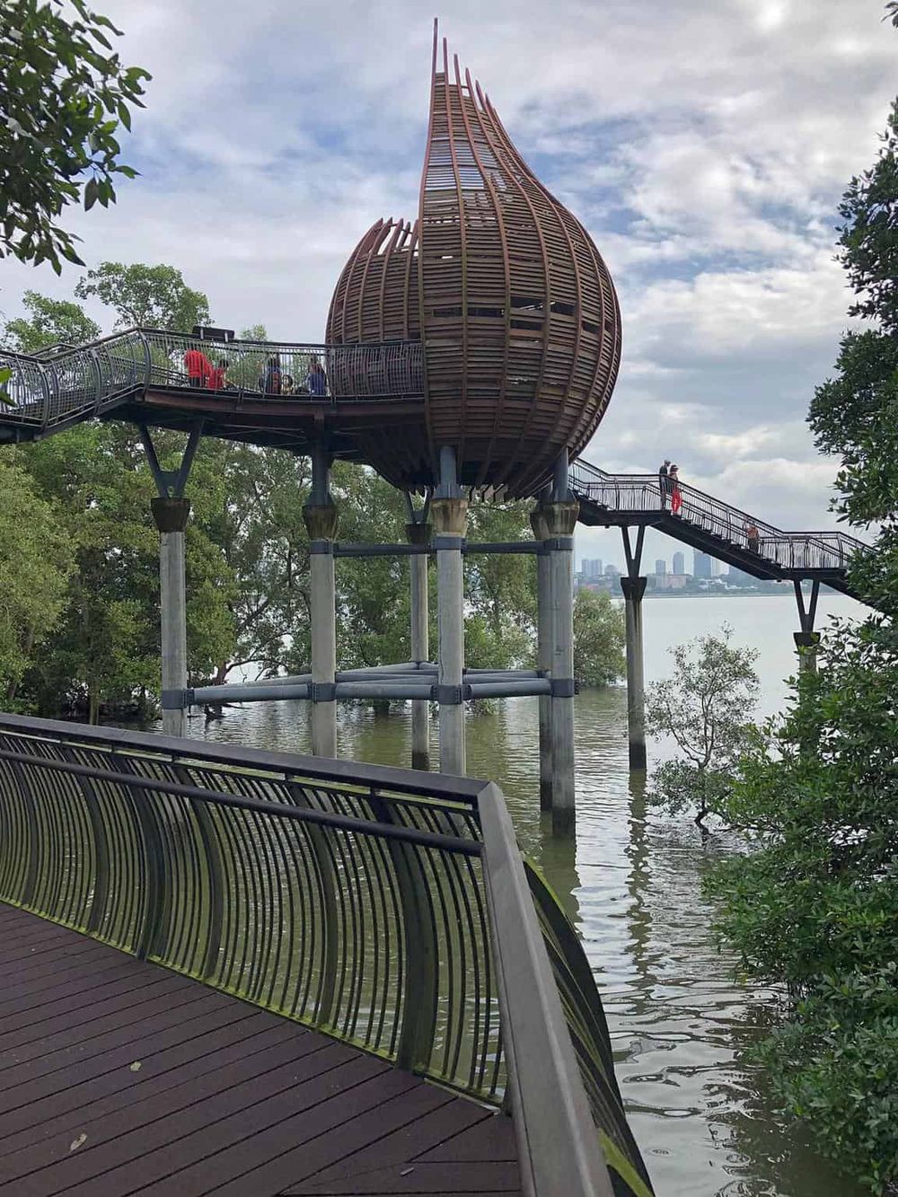 Unique treehouse village in trees with river views and walking bridge, located in Bangkok, Thailand.