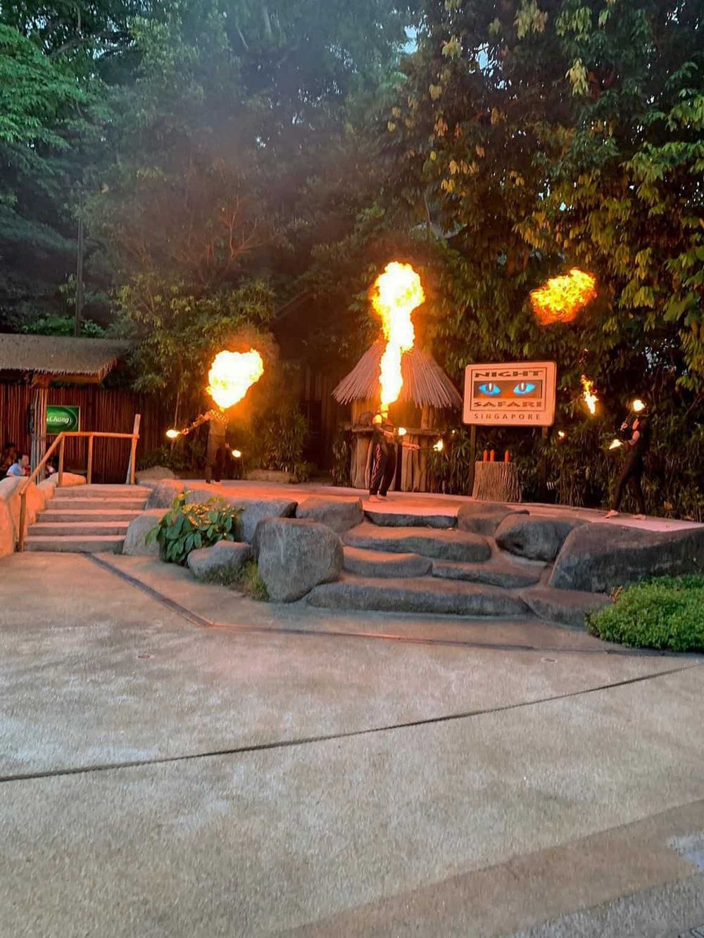 Vibrant fire dance performance at Quest for Directions amusement park in Singapore.