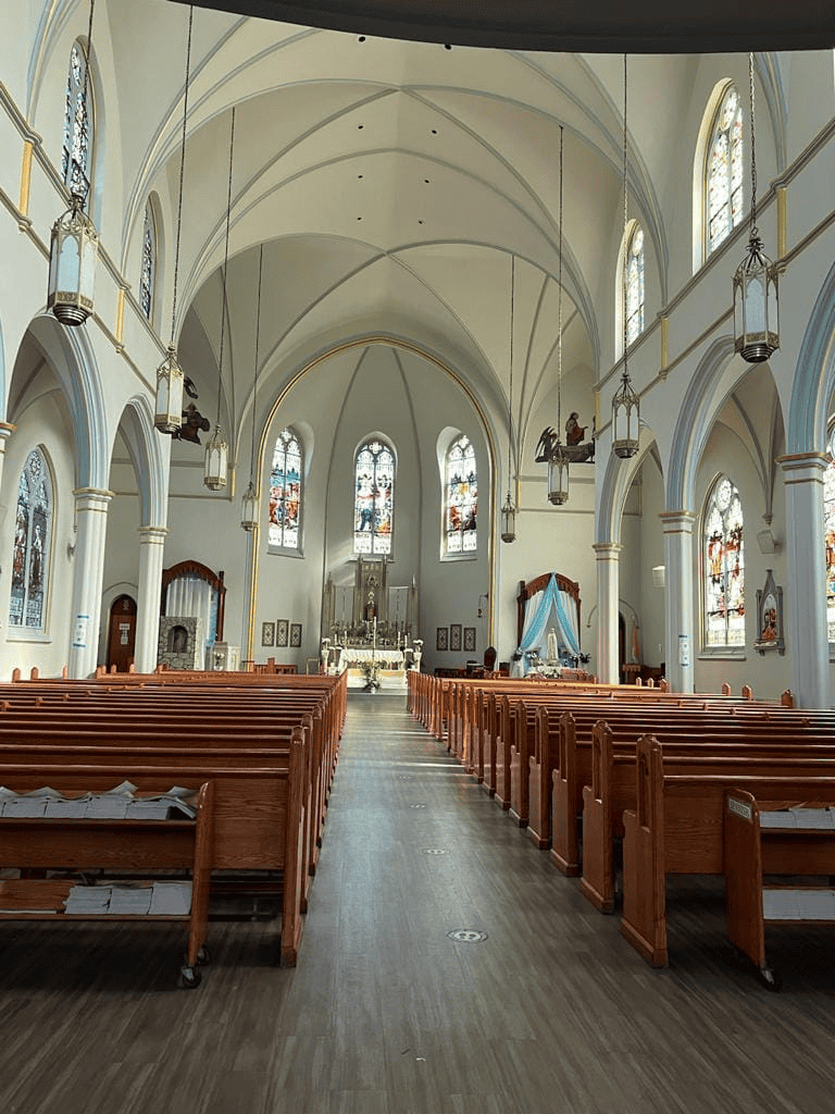 Serene church interior with stained glass windows and wooden pews, perfect for worship and spiritual reflection.