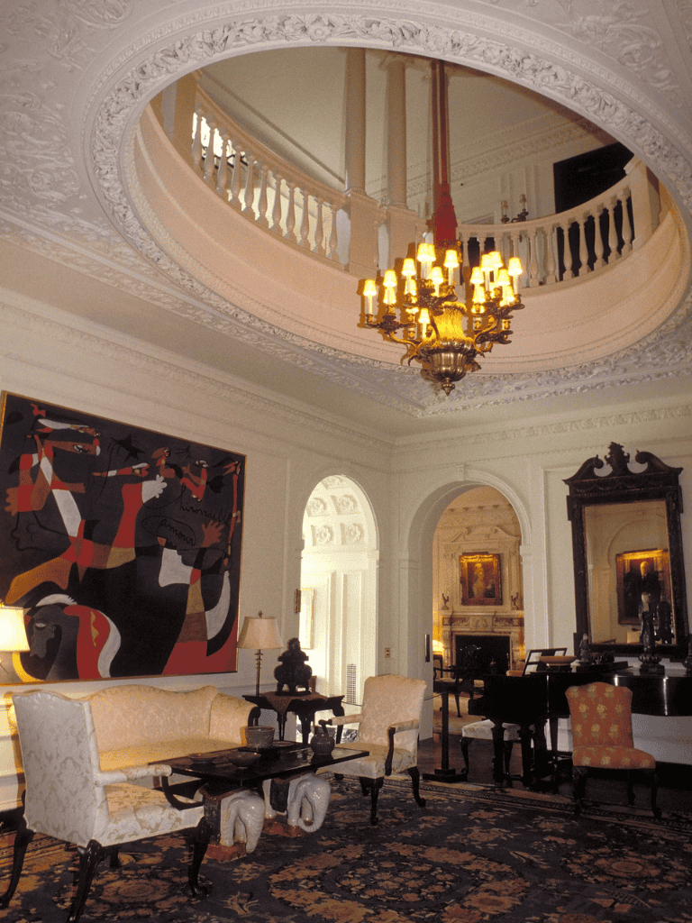 Elegant interior of a historic hotel lobby with ornate ceiling, chandelier, and classic furnishings.