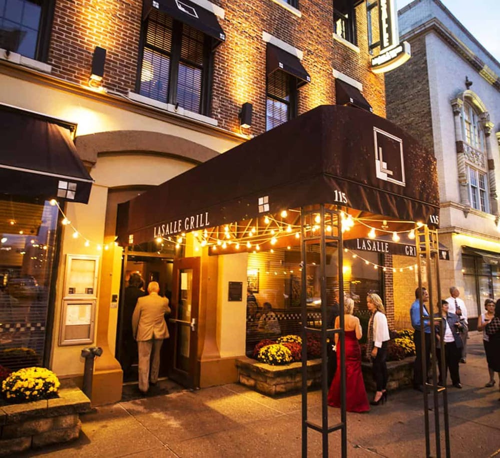 Charming downtown restaurant LaSalle Grill with outdoor seating and evening ambiance.