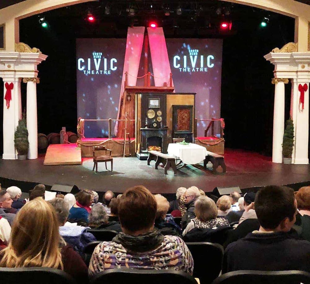 Vintage theater stage with props and audience, promoting local civic theater performances.