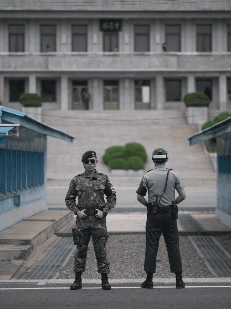 Riot police standing guard in front of a government building, security, law enforcement, public safety, peacekeeping, police officers in uniform.