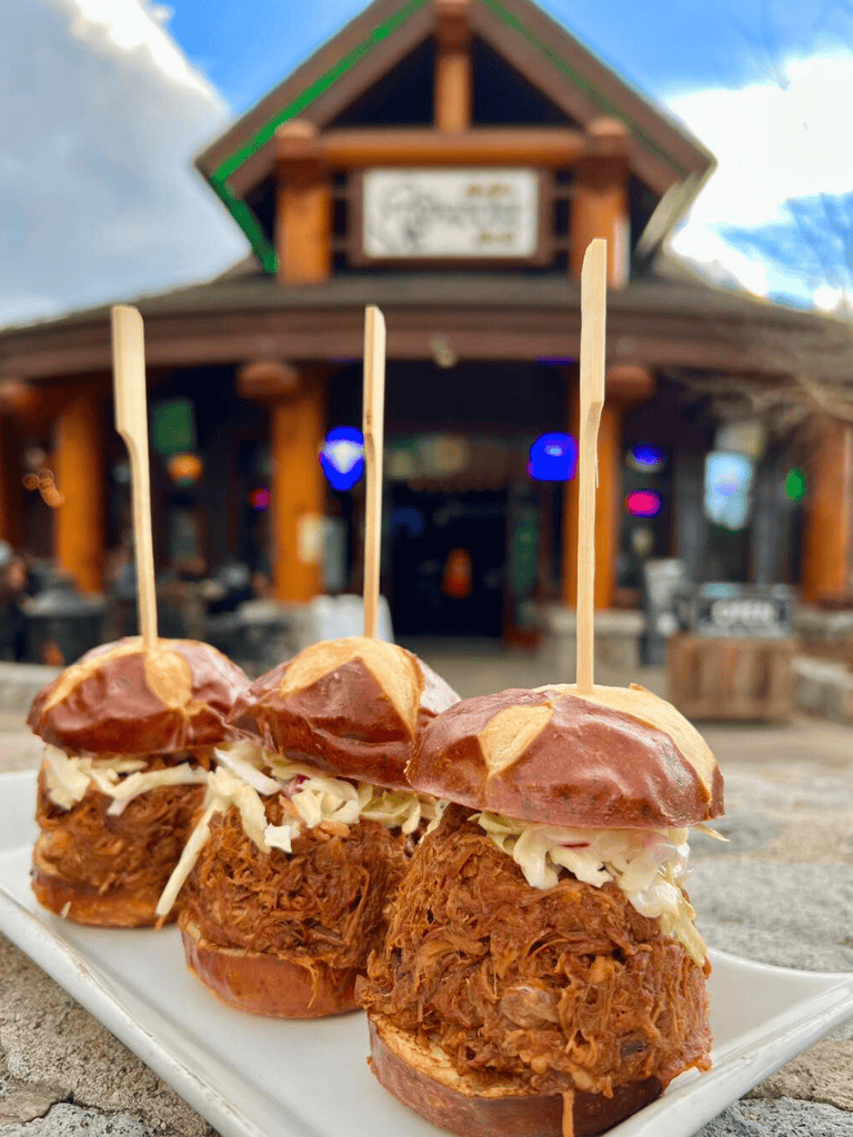 Slow Cooker BBQ Pulled Pork Sliders at Quest for Directions restaurant, outdoor dining, savory and tender meat.