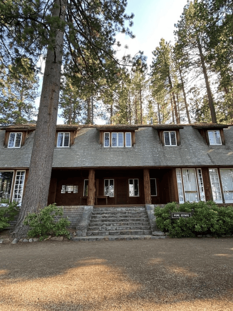 Quiet wooded retreat on a multi-story lodge surrounded by tall pine trees.