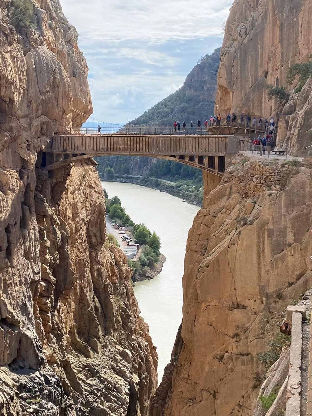 Stunning canyon walkway overlooking the river and rugged cliffs, popular trail for sightseeing and adventure enthusiasts.